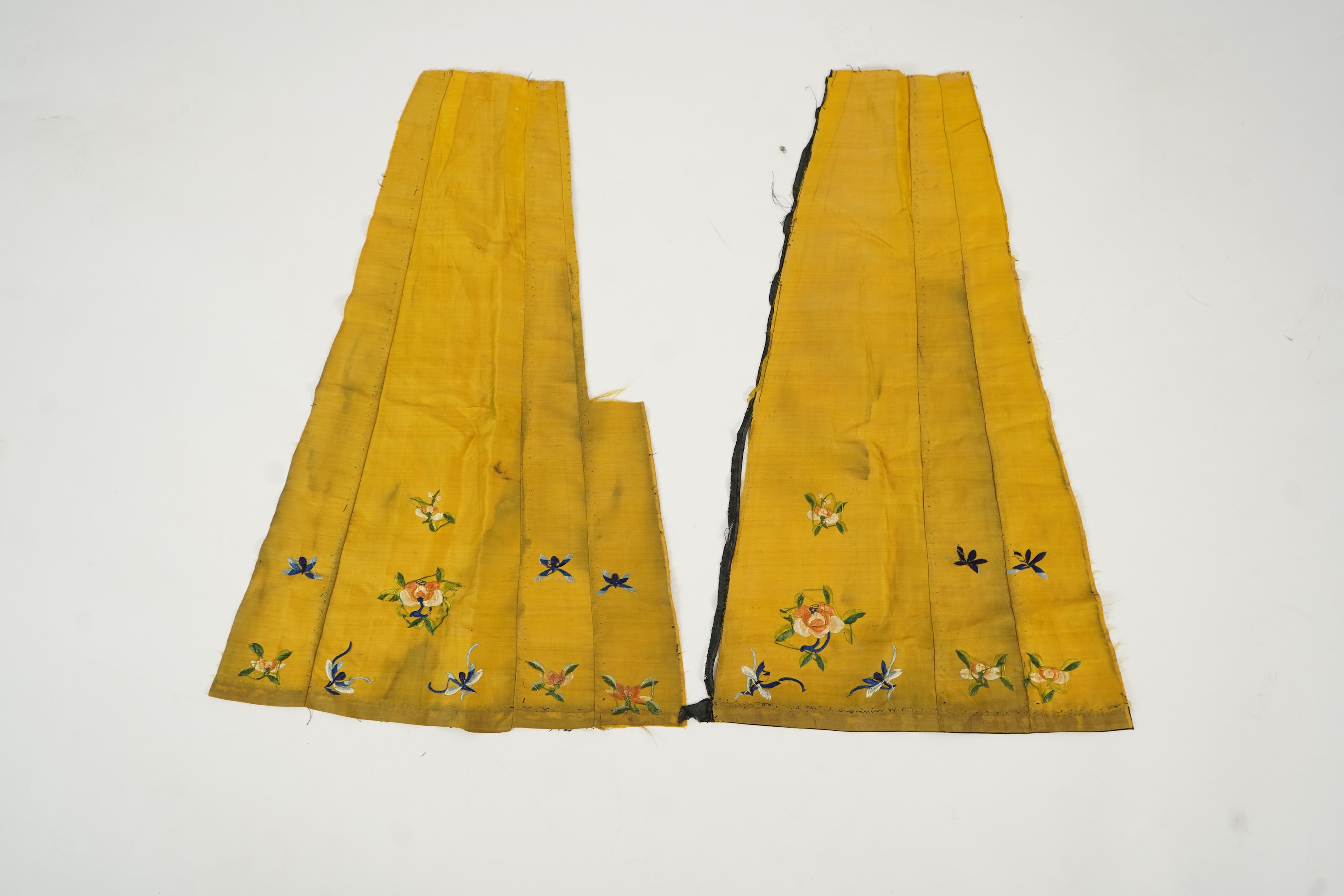 Two Chinese embroidered silk wedding skirts, late Qing, five hats, trousers, two skirt panels and two others, collar and a panel
